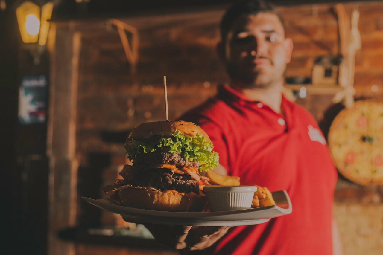 Delicious gourmet burger with fries served indoors at a restaurant in Brazil.